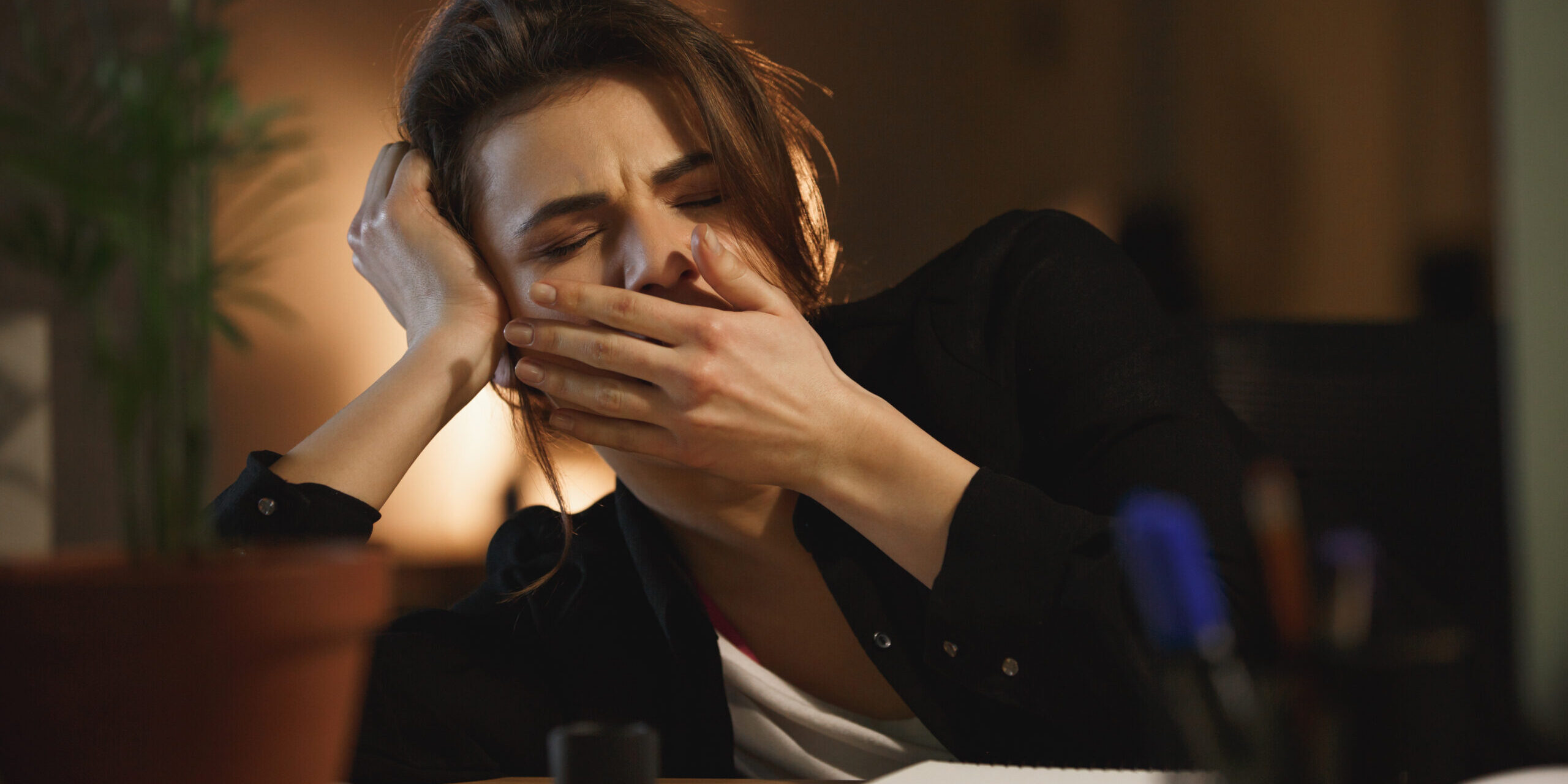 Woman yawning in office